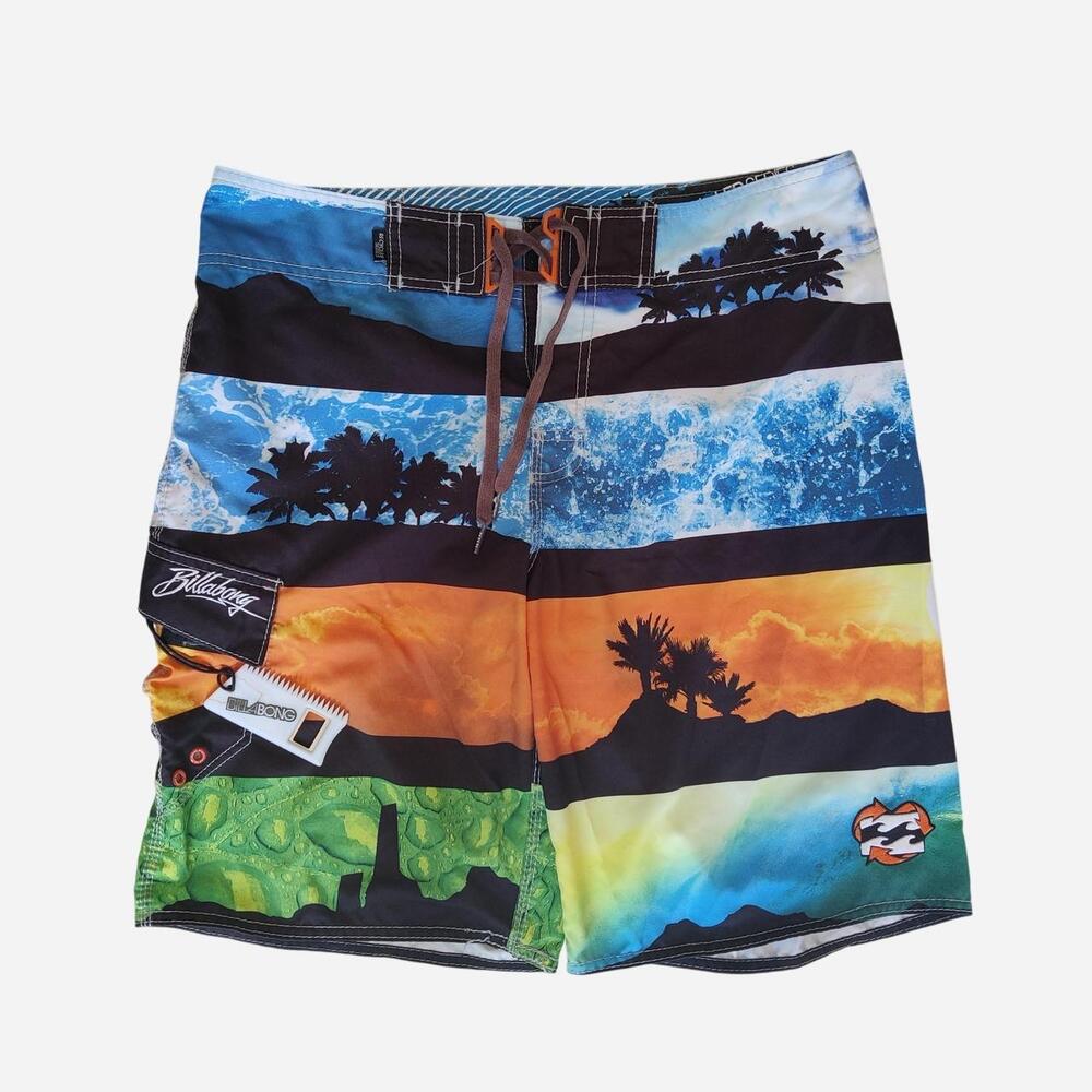 Billabong board shorts with sunset, palm trees, and ocean waves graphic